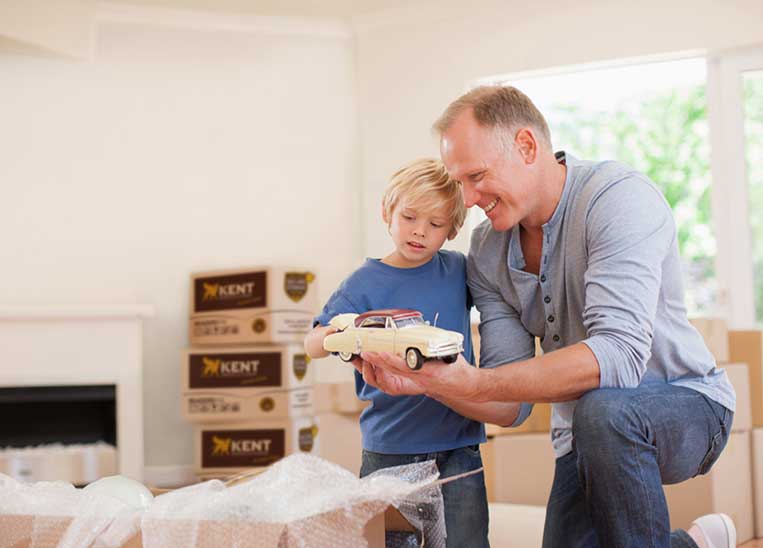 Grandpa with boy and plane and packing boxes