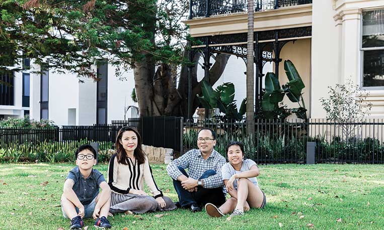 Family sitting on the grass outside The Moreton, Bondi