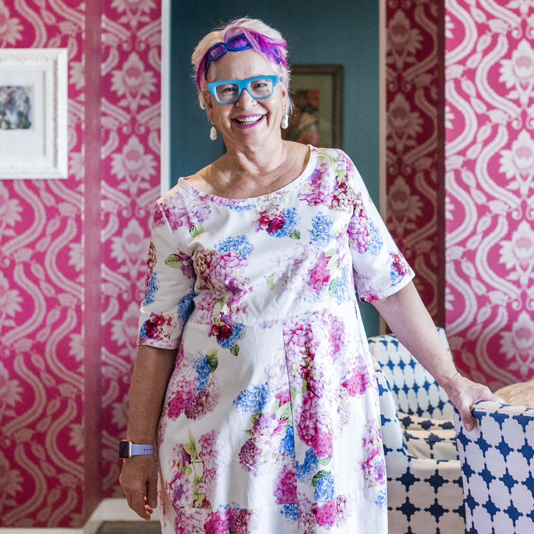 Woman In Front of Pink Wallpaper